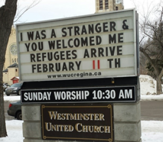 The sign outside Westminster United Church says "I was a stranger and you welcomed me. Refugees arrive February 11."