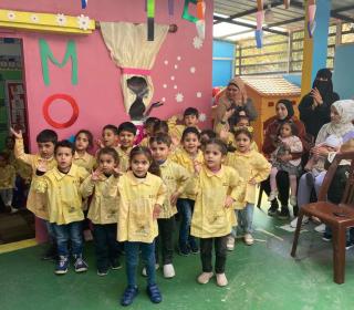 A kindergarten class poses for the camera