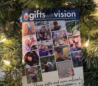 The 2023 Gifts with Vision catalogue hangs on a Christmas tree