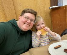 The author, Tori Mullins, with their daughter at a Shrove Tuesday dinner.