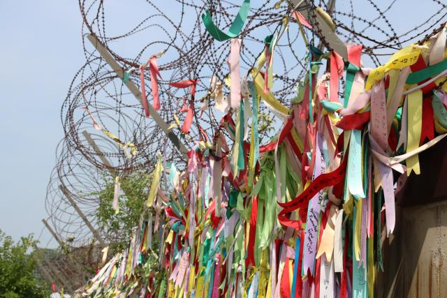 Multicoloured ribbons tied to the wall of the DMZ, Korea