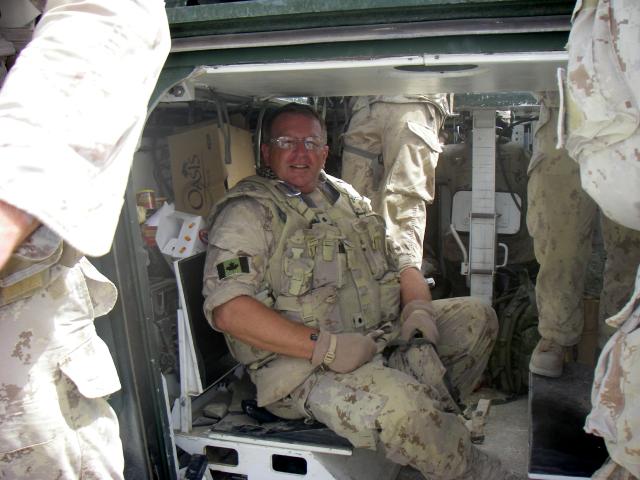 The Rev. Jim Short, in military fatigues, prepares for pastoral visitation in a war zone, as he heads out with a convoy to visit the troops at various forward operating bases and strong points in Afghanistan.