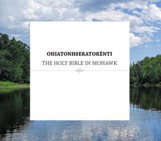 Text saying OHIATONHSERATOKÉNTI THE HOLY BIBLE IN MOHAWK in a white box against a photo of a river