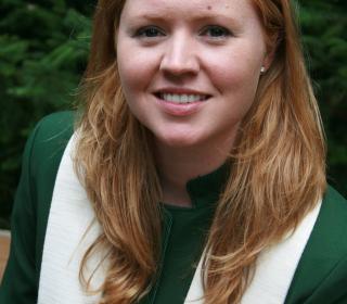 The author’s portrait from her first pastoral charge. She is a young woman with long blonde hair and is wearing a dark green jacket and white stole.