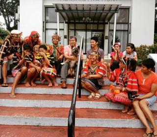 A group of Indigenous Lumad farmers and supporters sit for a photo on the steps of the seminary's Administration building.