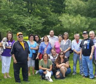 A group photo of members of the Naandwindizwin-Wechihitita Residential School Survivors Support Group together in a park.