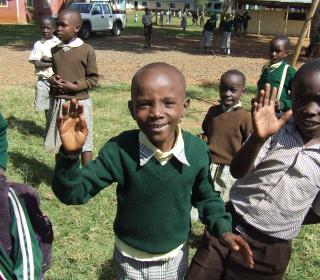 A group of happy primary school students in Kisumu, Kenya