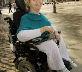 Tracy Odell in her power wheelchair on a Toronto street.
