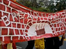A painted banner proclaims "Bread and Bricks"