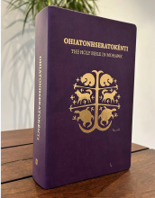 The Mohawk Bible has a purple cover with Indigenous art stamped in gold