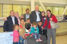 A group of United Church people gather with the Bakour family from Syria as they are welcomed to Canada.
