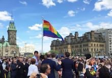 Prime Minister Justin Trudeau raising the rainbow Pride flag on Parliament Hill.