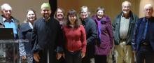 Members of Grace United Church stand in a group together with one of the members of Outaouais Islamic Center.