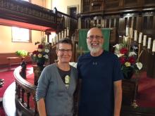 Moderator Jordan Cantwell and festival visionary Rev. David Moore together in a church.