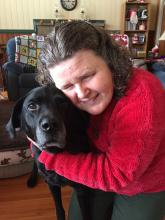 The author wraps her arms around her guide dog, Wilson.