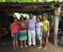 Fisherman Rigoberto Monge and his family are pictured near their home on the beach in El Salvador.