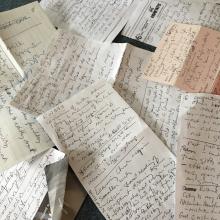 A pile of handwritten notes written by General Secretary Nora Sanders on scraps of paper during a talk by Rowan Williams.