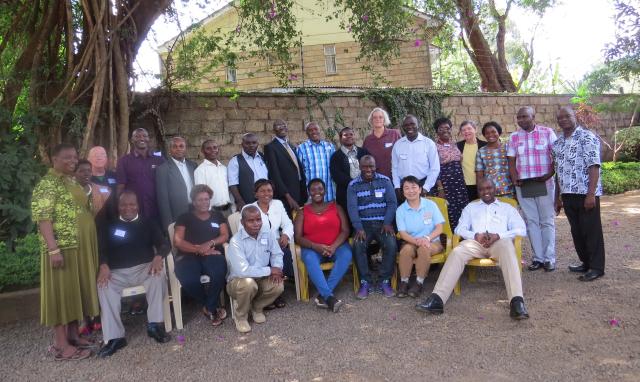 Kenyan graduates of the Asian Rural Institute and members of the visiting delegation. A large group of people gather for a photo in Kenya.