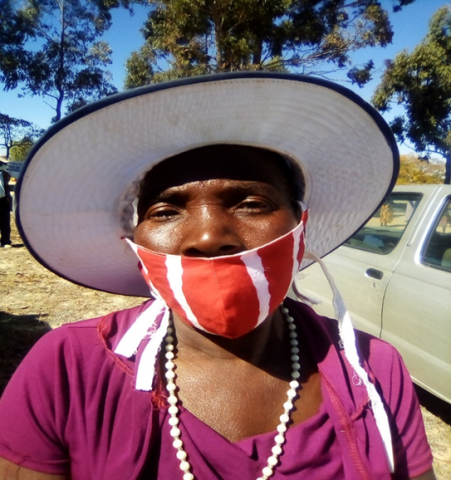 A woman in a hat and mask