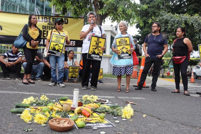 Demonstrators holding up signs defending the Santa Marta 5