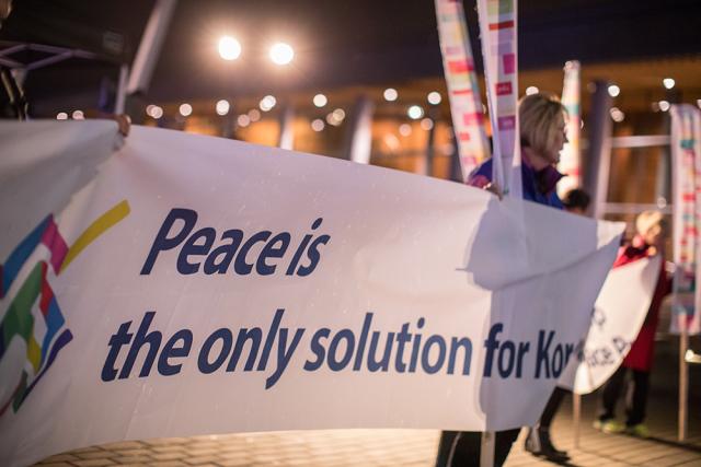 Candlelight vigil for Korea, Vancouver, January 15, 2018. Banner reading "Peace is the only solution for Korea"