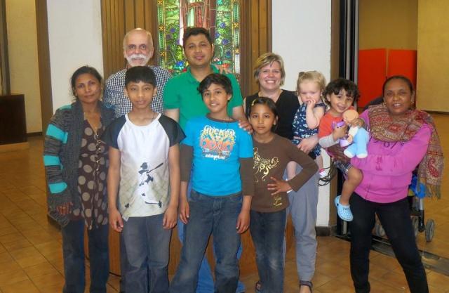 Rev. Bill Millar with the children and youth ministry of Knox United Church, Winnipeg, MB. Group photo of a diverse group of children and adults.