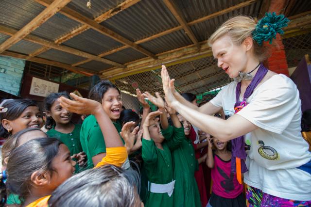 Clowns without Borders teach life-saving hygiene skills in a fun way to children at Kutupalong refugee camp, Cox’s Bazar, Bangladesh. A woman dressed as a clown interacts with children