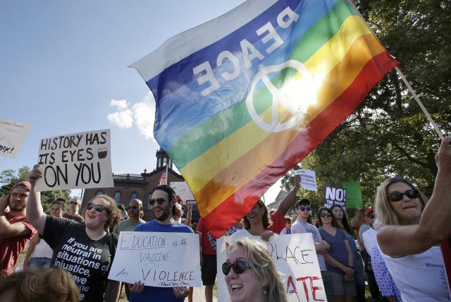 Photo of people holding signs and a flag for peace