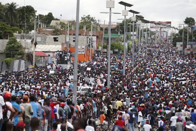 Anti-government protesters fill the street for a march in Port-au-Prince, Haiti, Sunday, Oct. 20, 2019. Anger over corruption, inflation and scarcity of basic goods has led to weeks of demonstrations asking for the resignation of President Jovenel Moise. Haiti