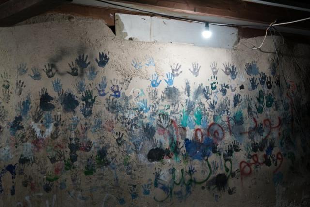 Photo of children's handprints in Khan al-Ahmar