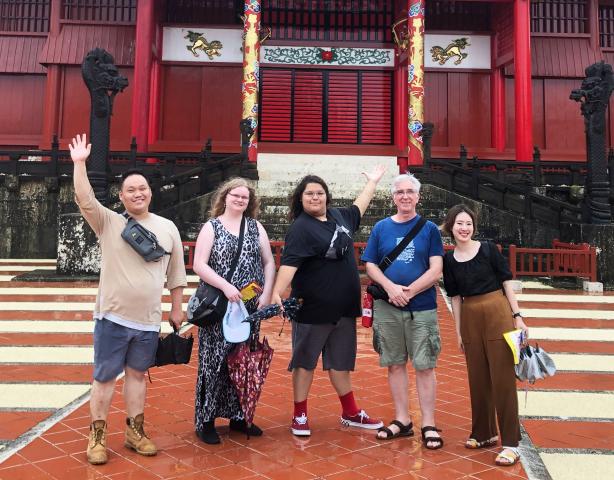 Participants in the Minority Youth Forum, including two youth featured in this blog post (centre), pose for a group shot in front of a Japanese temple.