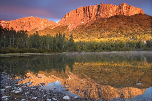 Yamnuska (Mount John Laurie) in Kananaskis Country, AB A golden sun shines on Mount John Laurie, known as Yamnuska, in Alberta.