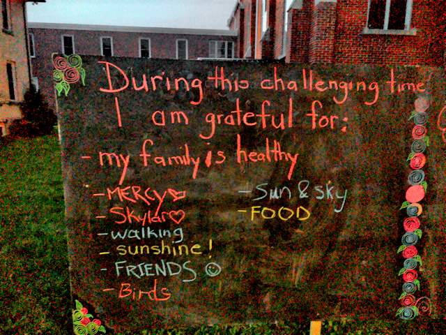 An interactive gratitude installation set up outside Mount Forest United Church. Outdoor blackboard inviting people to write what they're grateful for