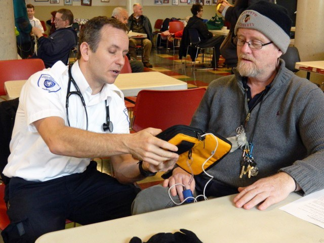 A client receives medical treatment at Our Place, Victoria, BC.