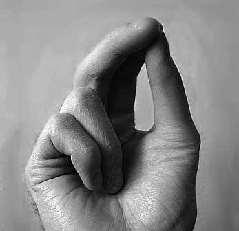 A white hand with fingers in the position of making the Sign of the Cross in the Eastern Orthodox tradition, with three fingers together.