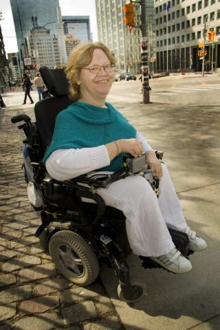 Tracy Odell in her power wheelchair on a Toronto street.