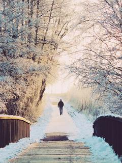 Man walking on a snowy trail